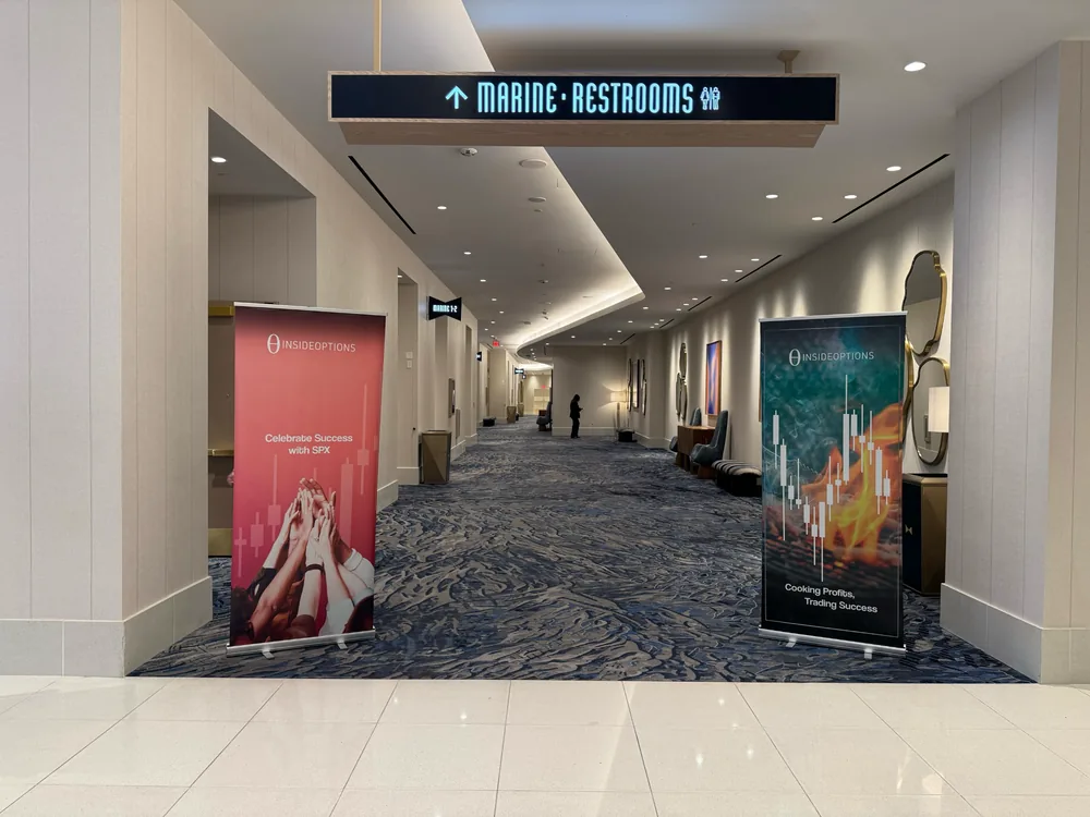 Two InsideOptions roll-up banners standing in a hotel corridor at an event